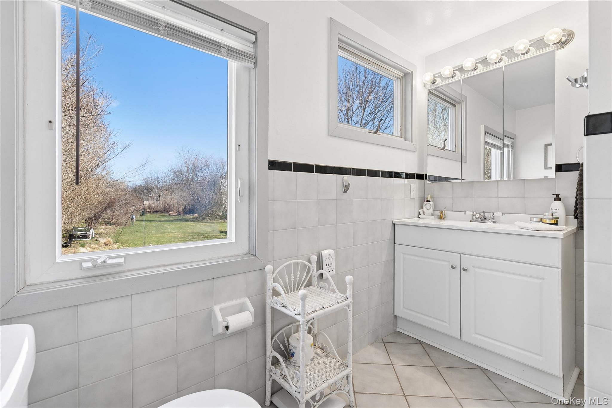 20 Mitchell Road Westhampton Beach, NY 11978 - Photo 14 of 34 a bathroom with a window a sink and a mirror