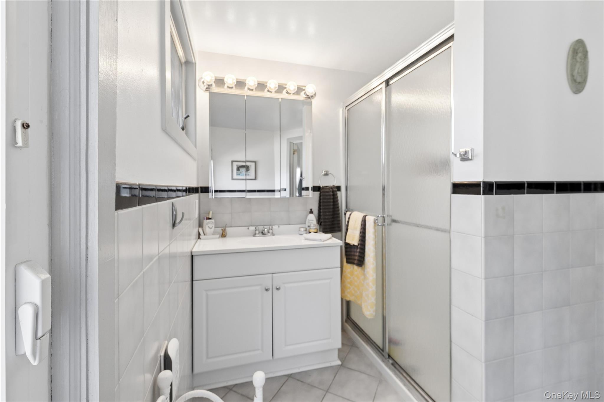 20 Mitchell Road Westhampton Beach, NY 11978 - Photo 15 of 34 a bathroom with a sink and mirror