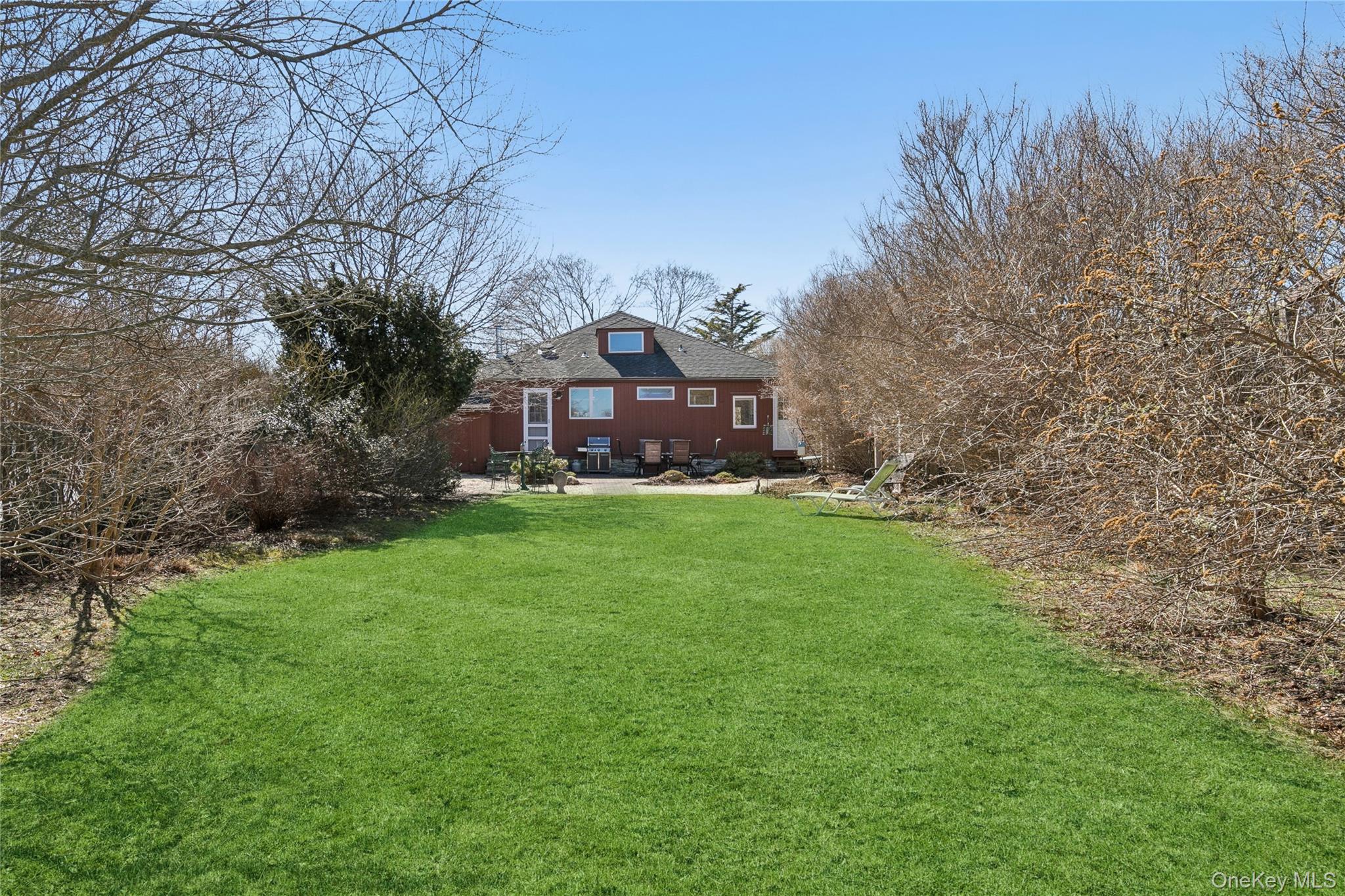 20 Mitchell Road Westhampton Beach, NY 11978 - Photo 26 of 34 a view of a big house with a big yard and large trees