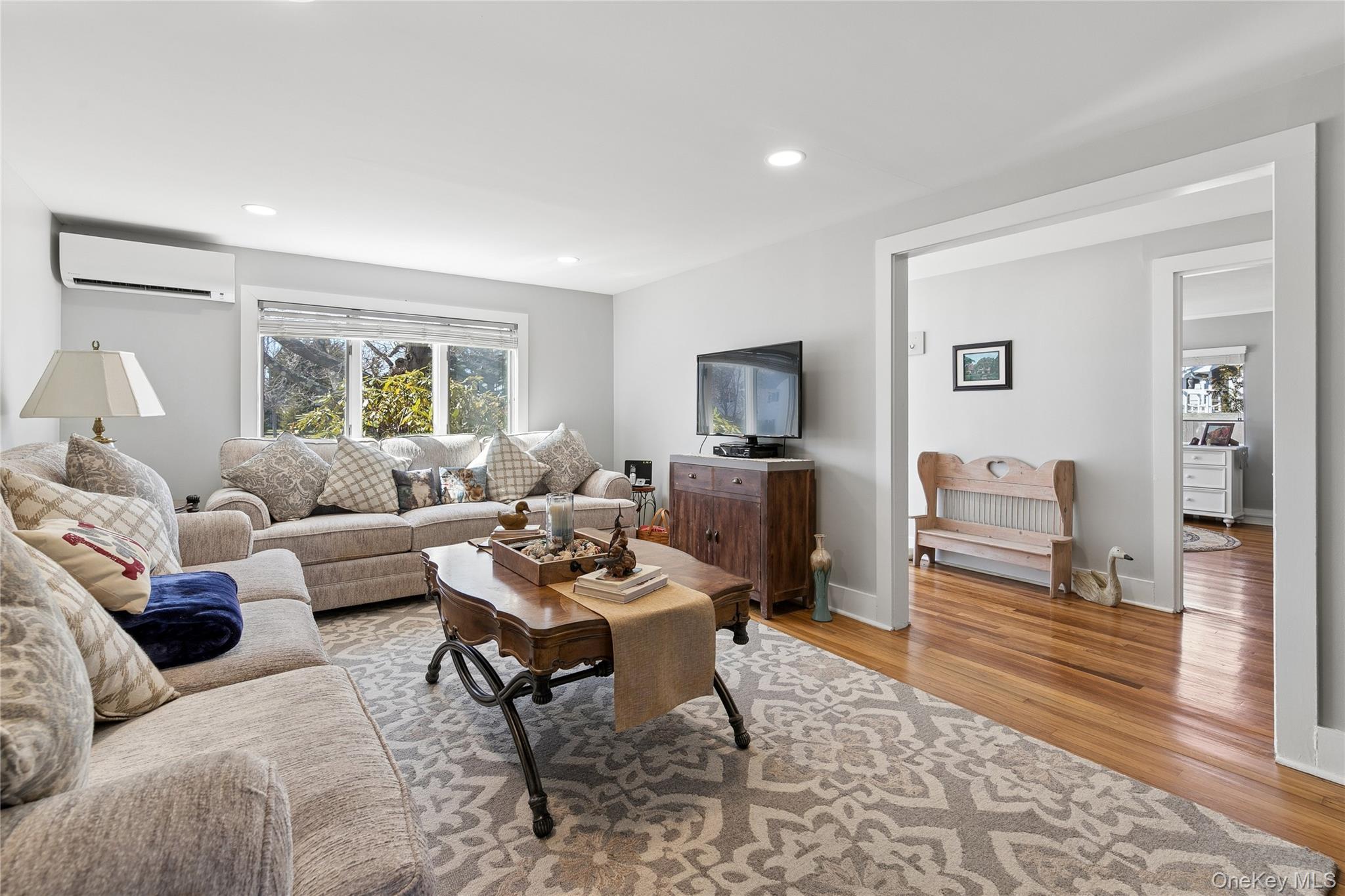 20 Mitchell Road Westhampton Beach, NY 11978 - Photo 5 of 34 a living room with furniture a rug a window and a flat screen tv
