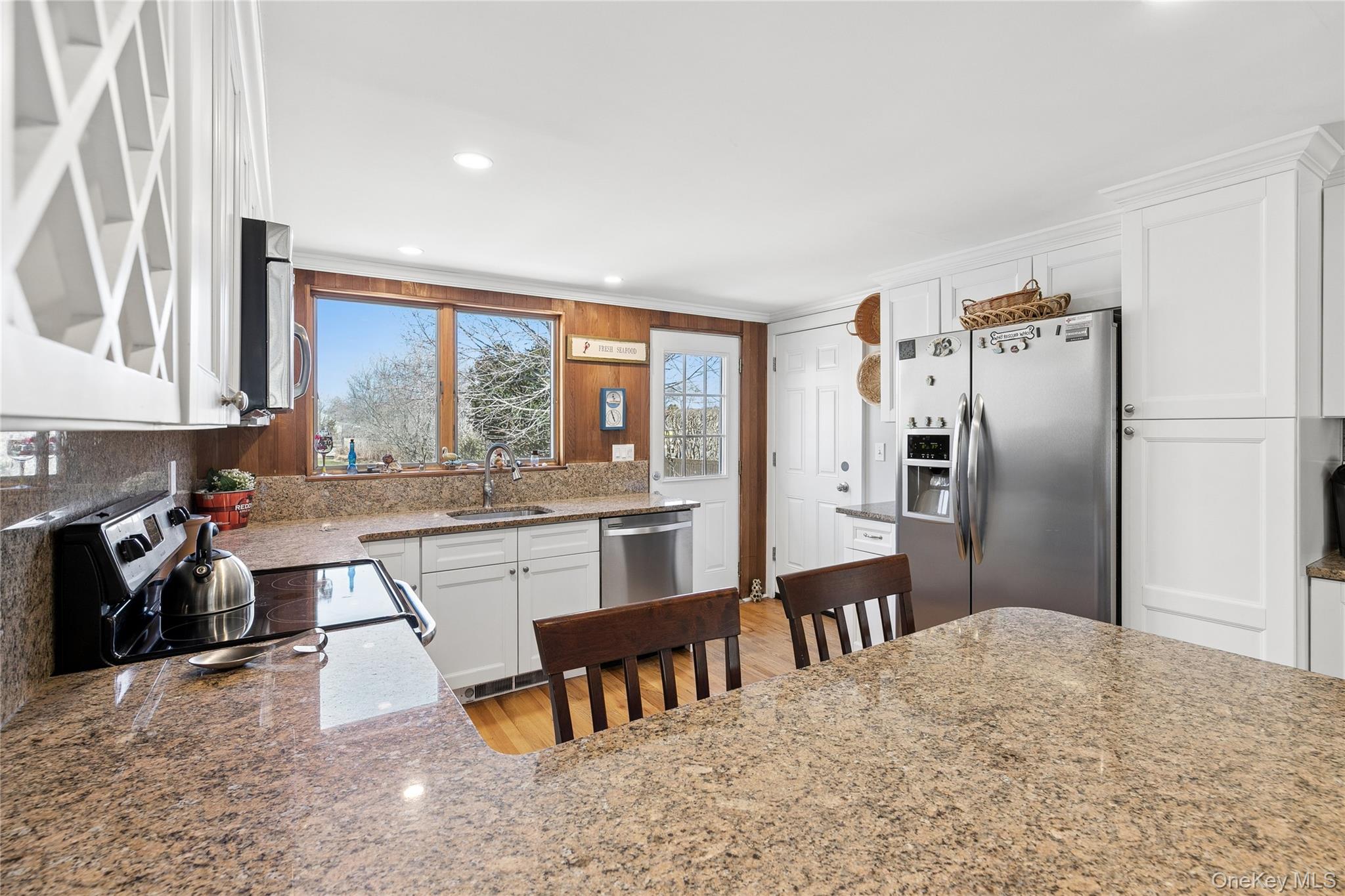 20 Mitchell Road Westhampton Beach, NY 11978 - Photo 9 of 34 a kitchen with granite countertop a refrigerator stove top oven and sink