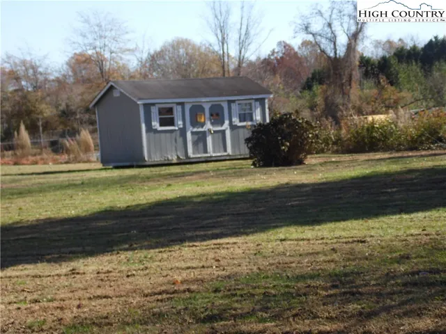 a view of a yard with mountain and trees around