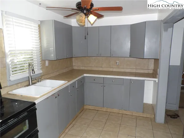 a kitchen with a sink cabinets and window