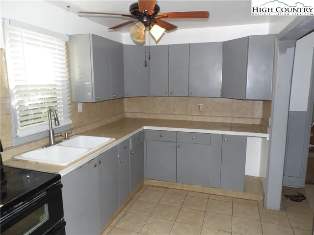 a kitchen with a sink cabinets and window