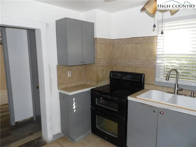 a kitchen with a sink and a stove top oven