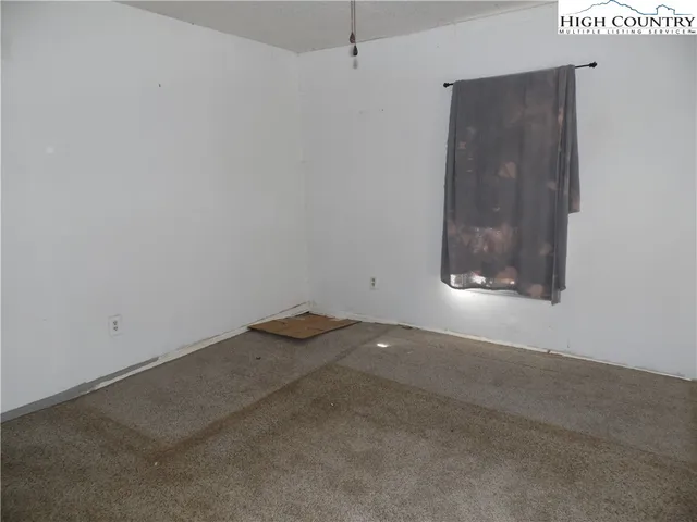 an empty room with a empty space and window