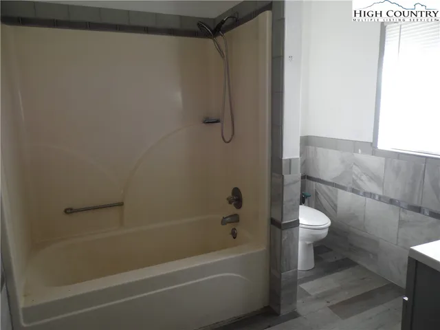 a bathroom with a shower and a toilet