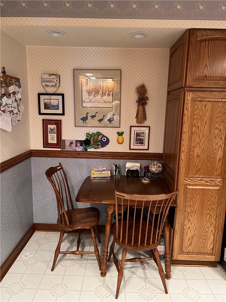 6830 Gun Club Road Coopersburg, PA 18036 - Photo 15 of 30 A cozy corner perfect for casual meals, featuring rich wooden cabinetry and patterned walls.