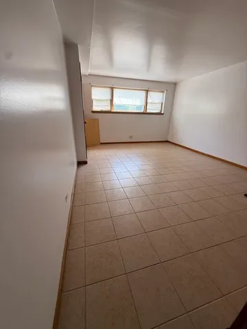 a view of an empty room with windows