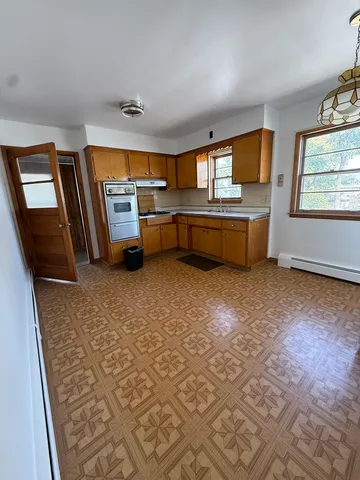 an empty room with a empty space and windows