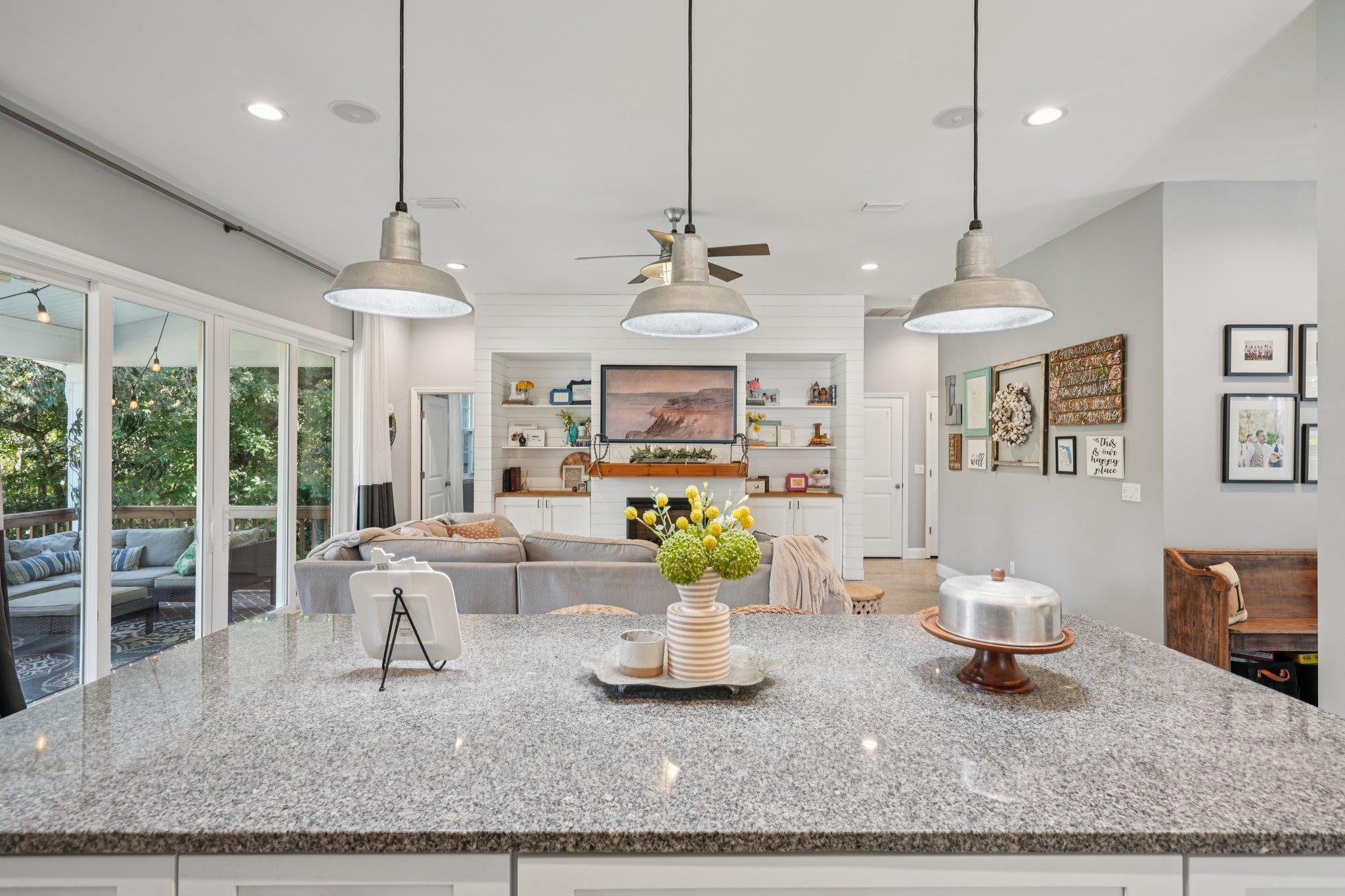 a living room with patio furniture and a chandelier