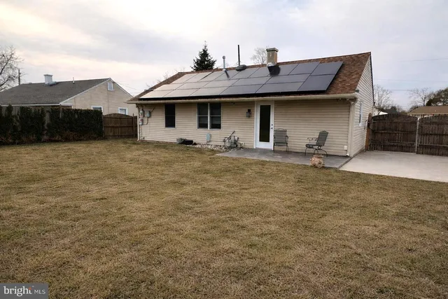 a front view of a house with many windows