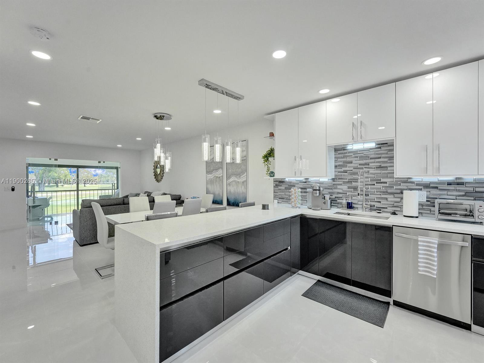 21860 Arriba Real, Unit 4D Boca Raton, FL 33433 - Photo 1 of 55 a kitchen with counter top space sink stainless steel appliances and window