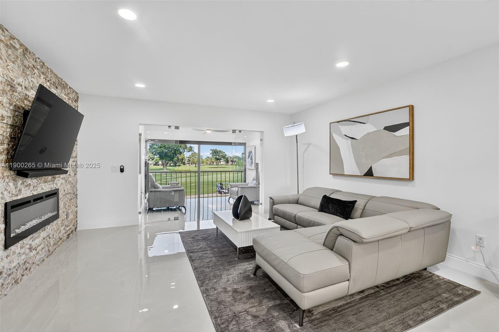 21860 Arriba Real, Unit 4D Boca Raton, FL 33433 - Photo 11 of 55 a living room with furniture and a flat screen tv