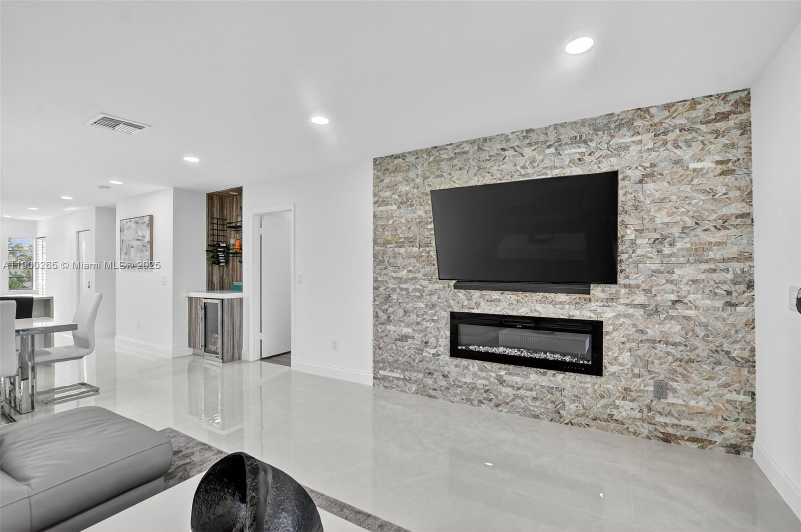 21860 Arriba Real, Unit 4D Boca Raton, FL 33433 - Photo 15 of 55 a living room with furniture a flat screen tv and a fireplace