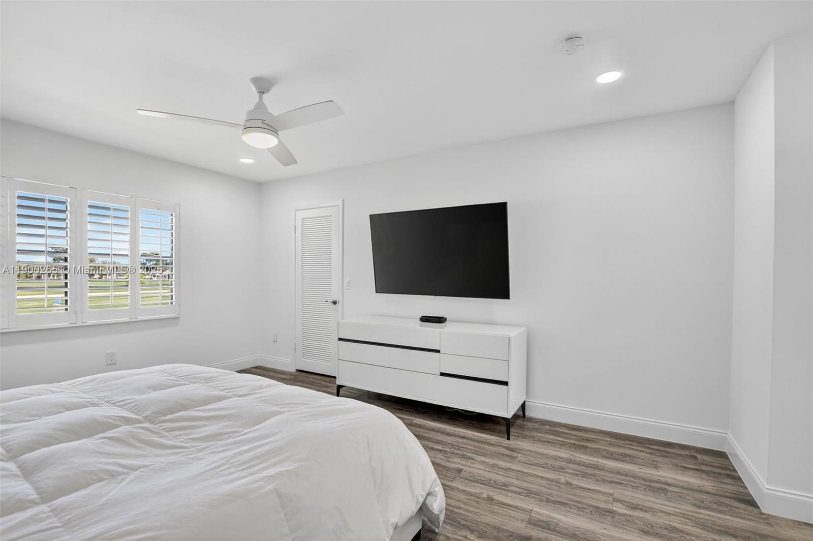 21860 Arriba Real, Unit 4D Boca Raton, FL 33433 - Photo 17 of 55 a bedroom with a bed tv and a window