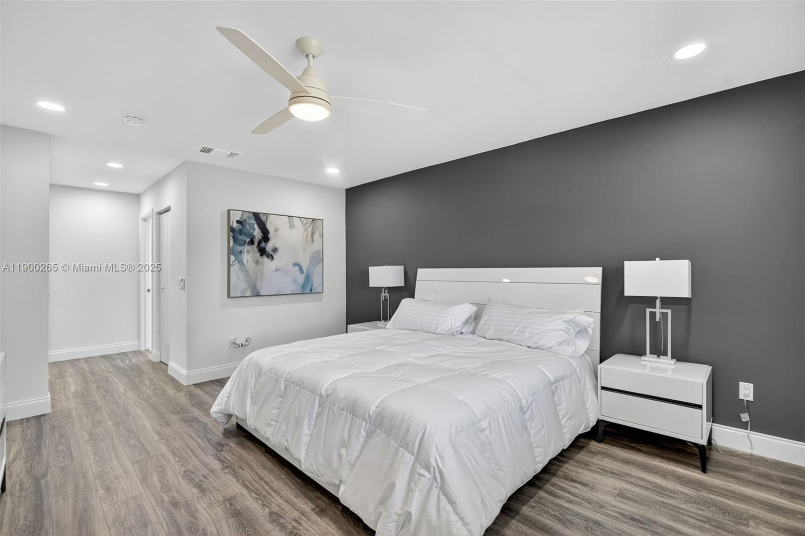 21860 Arriba Real, Unit 4D Boca Raton, FL 33433 - Photo 18 of 55 a spacious bedroom with a bed and a painting on the wall