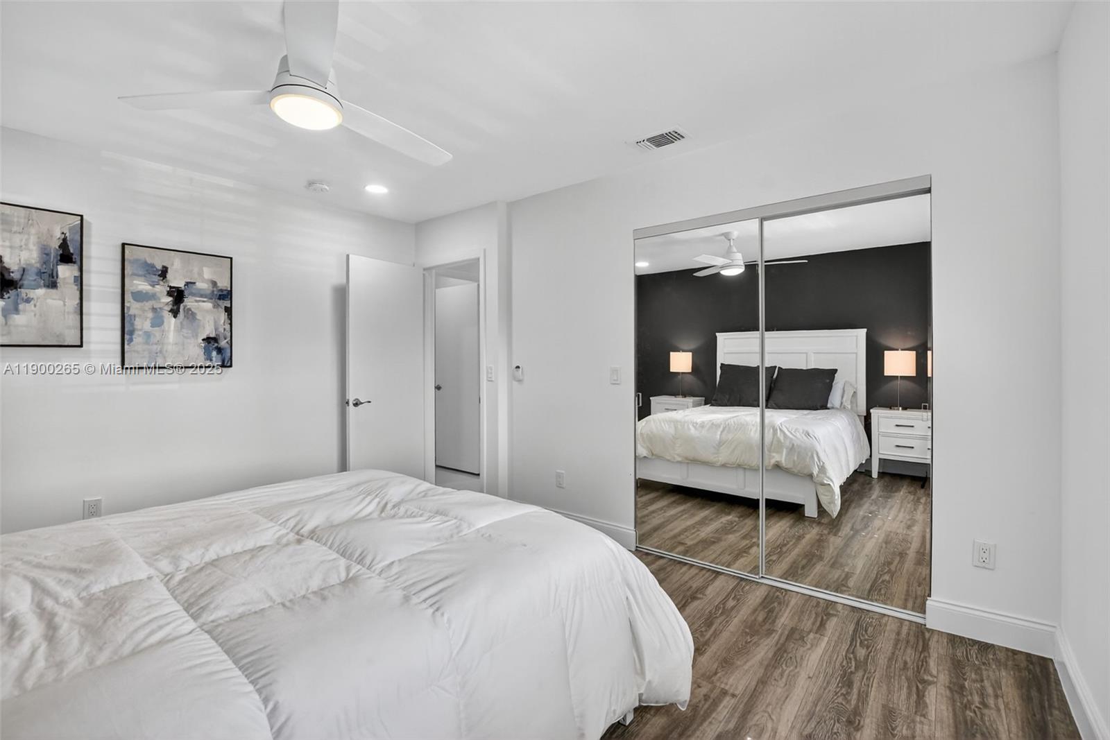21860 Arriba Real, Unit 4D Boca Raton, FL 33433 - Photo 23 of 55 a bedroom with a bed and a walk in closet