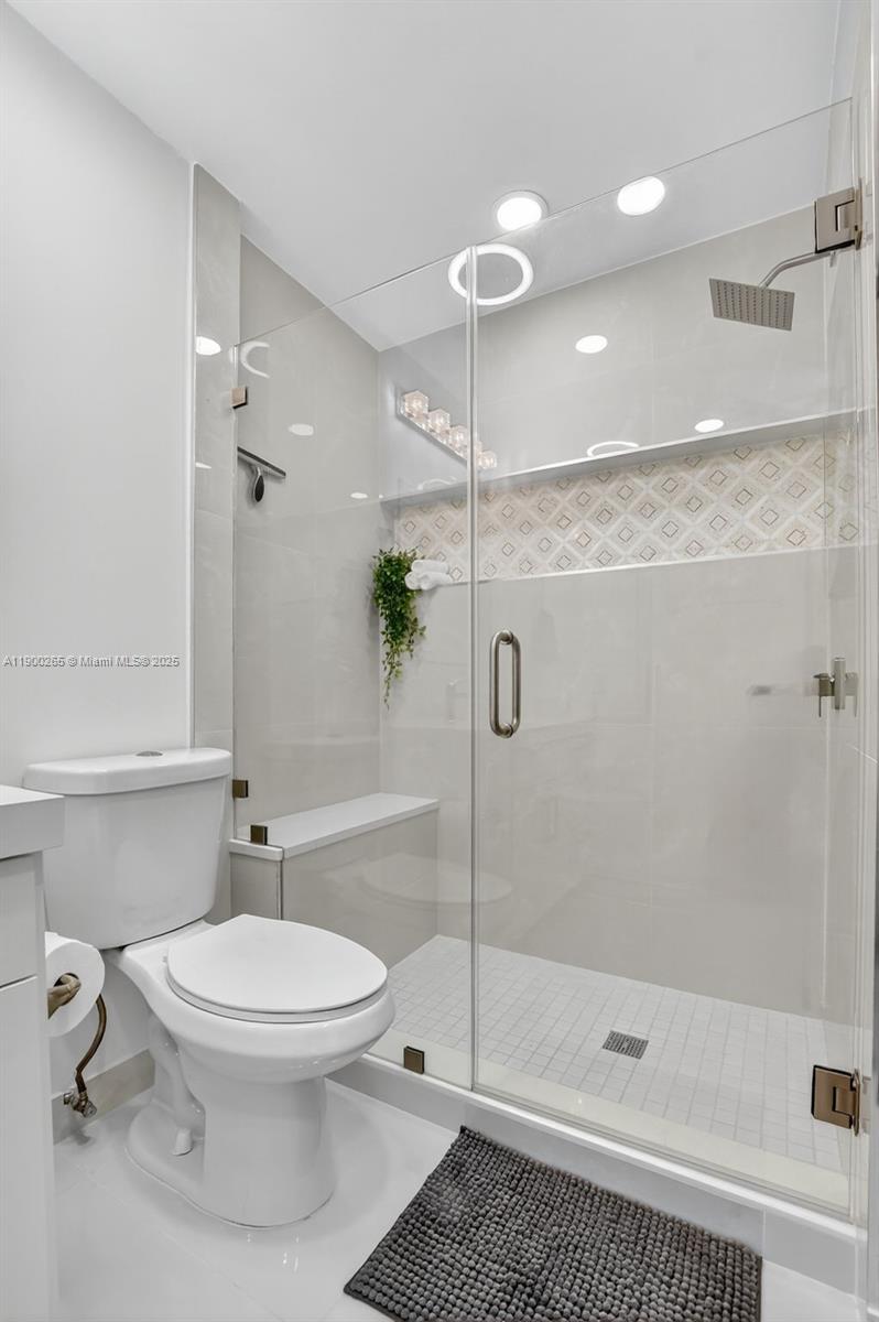 21860 Arriba Real, Unit 4D Boca Raton, FL 33433 - Photo 25 of 55 a bathroom with a toilet and a shower