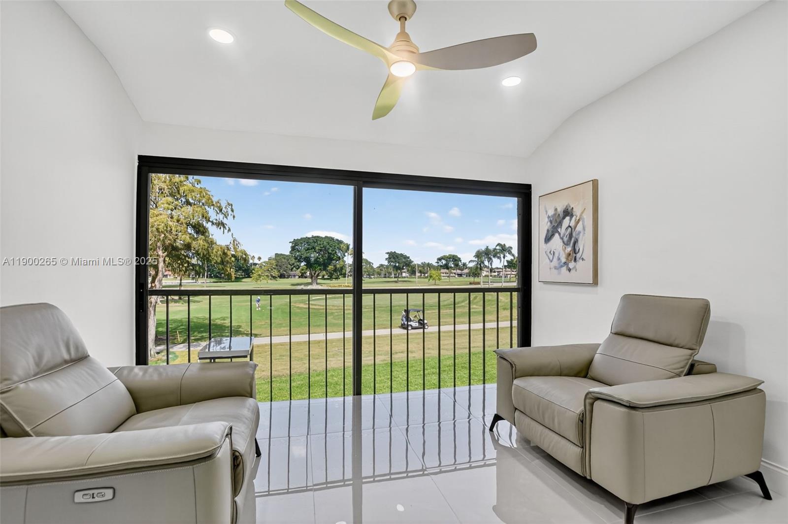 21860 Arriba Real, Unit 4D Boca Raton, FL 33433 - Photo 29 of 55 a living room with furniture and a floor to ceiling window