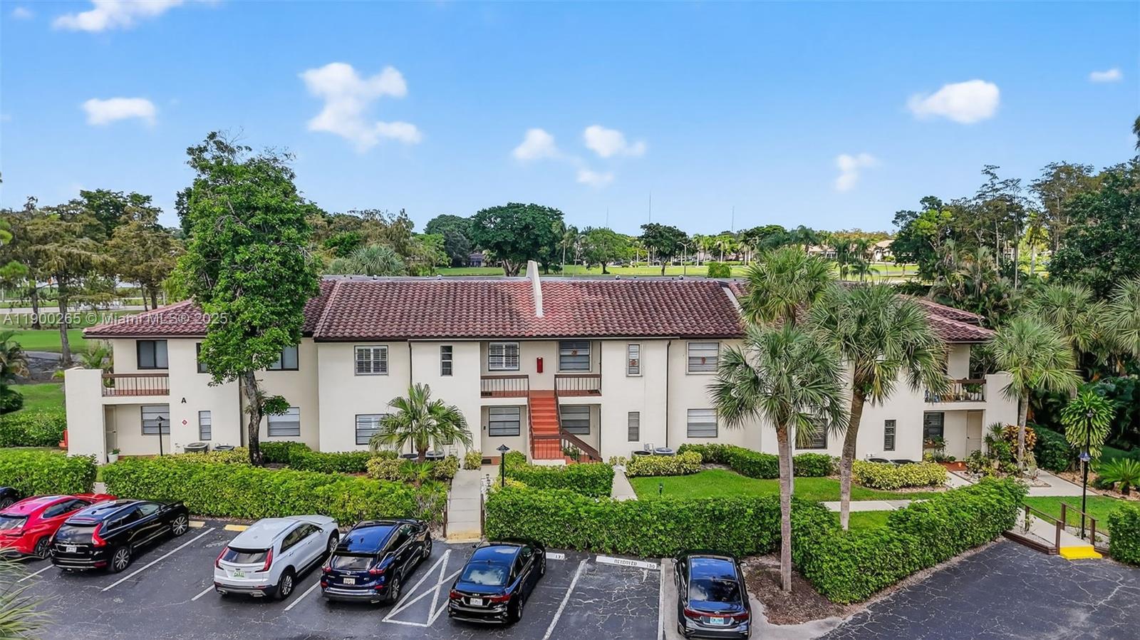 21860 Arriba Real, Unit 4D Boca Raton, FL 33433 - Photo 31 of 55 a front view of a house with a garden and plants