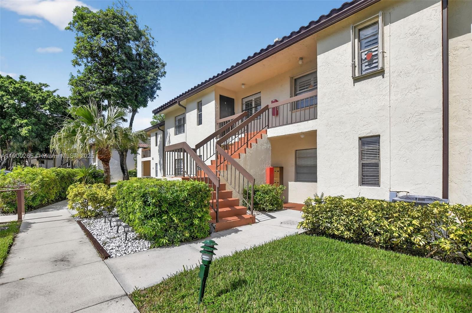 21860 Arriba Real, Unit 4D Boca Raton, FL 33433 - Photo 54 of 55 a front view of a house with a garden