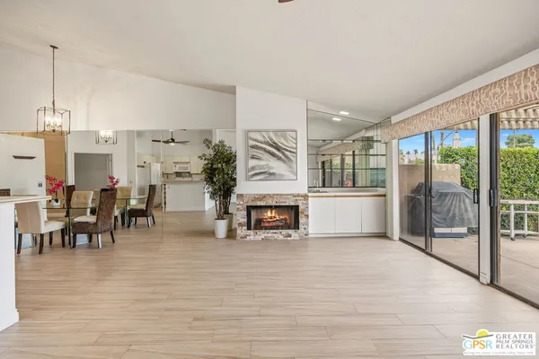 a view of a livingroom with wooden floor and a bathroom