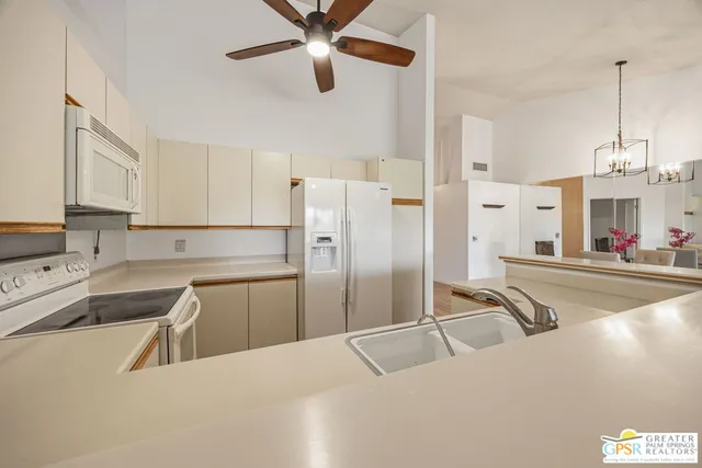 a kitchen with cabinets appliances and a sink
