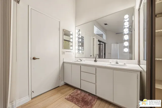 a bathroom with a granite countertop sink a toilet and shower