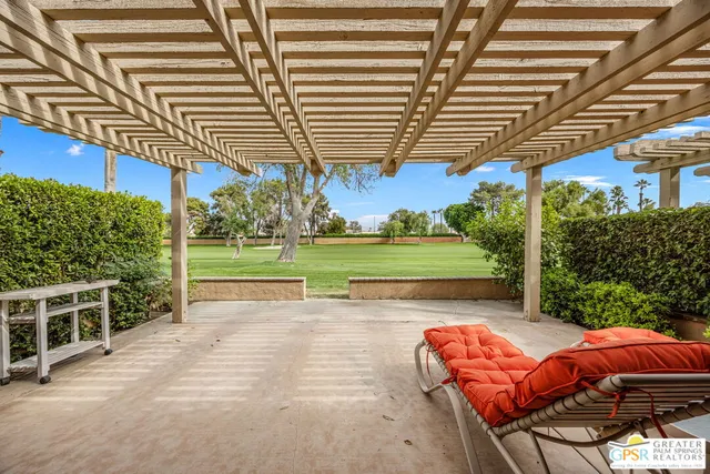 a roof deck with table and chairs and potted plants