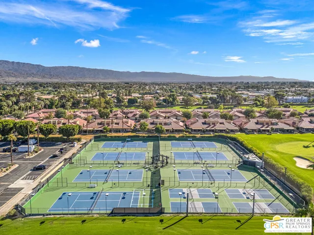 a swimming pool with outdoor seating and yard