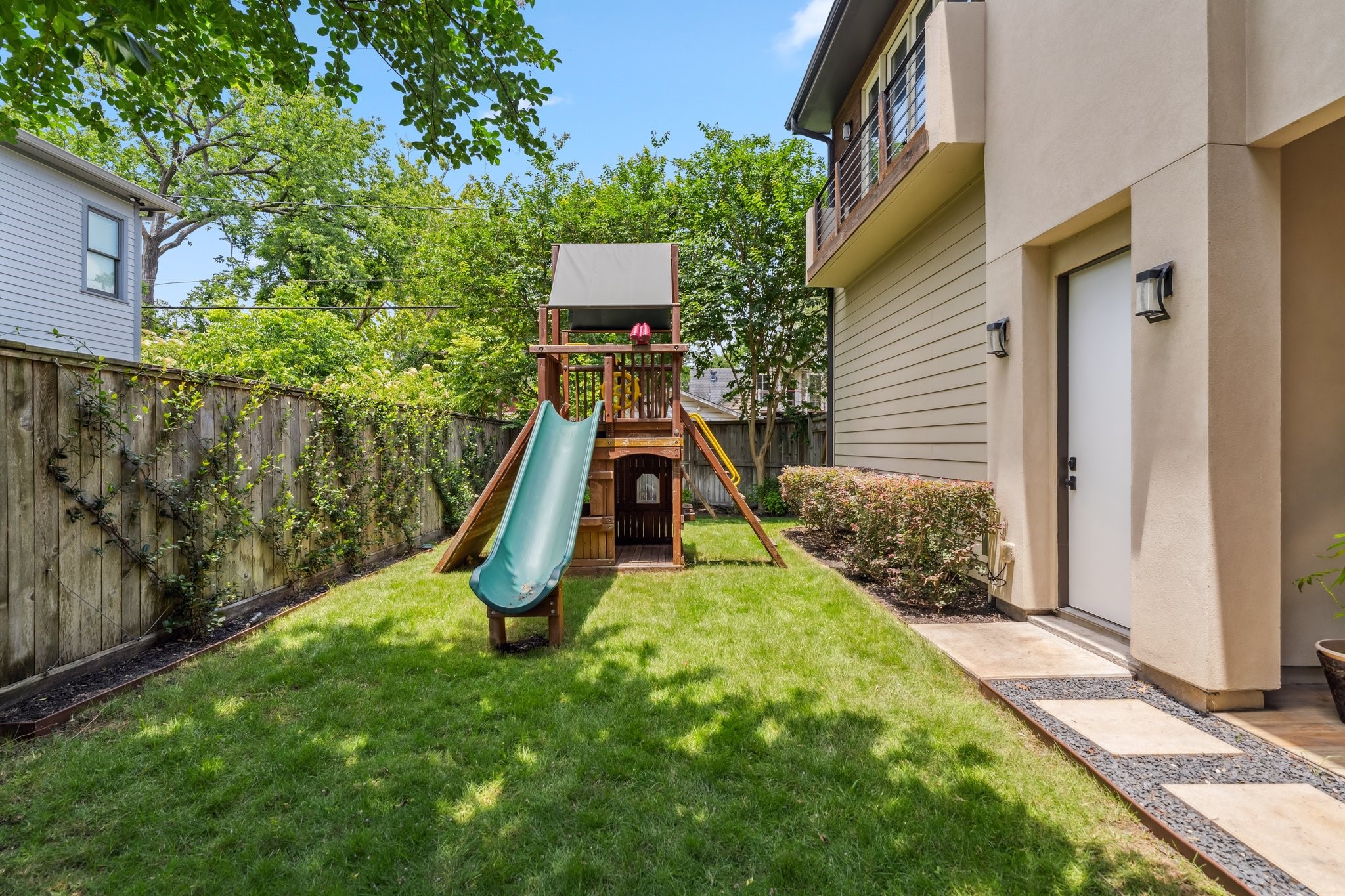 815 East 27th Street Houston, TX 77009 - Photo 36 of 44 This beautiful backyard offers a large fenced-in green space with plenty of room to add a pool, making it perfect for outdoor fun and relaxation. The backyard playset (2020) adds instant family-friendly appeal. Professionally landscaped with sprinklers covering the lawn, flower beds, shrubs, and vines, the outdoor space is both lush and easy to maintain.
