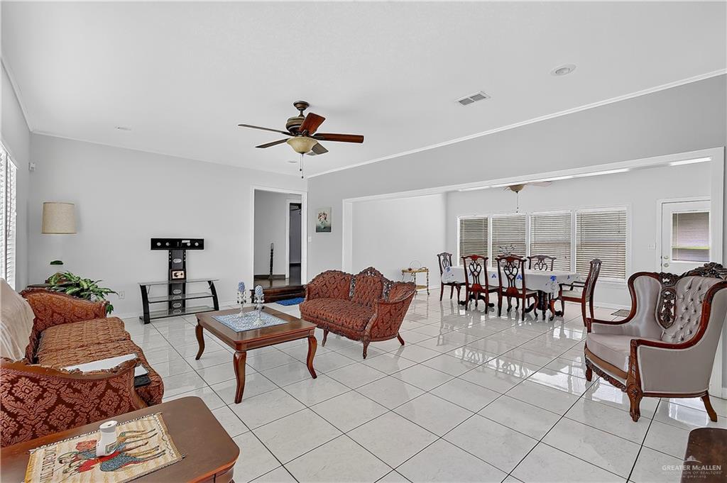 216 West Enfield Road Edinburg, TX 78539 - Photo 5 of 20 Expansive living area featuring tile flooring, ceiling fan, and white window blinds