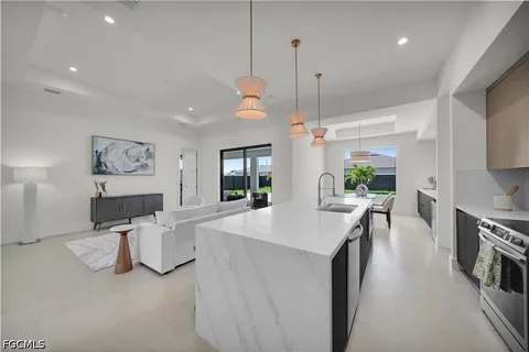 a kitchen with a sink and white cabinets