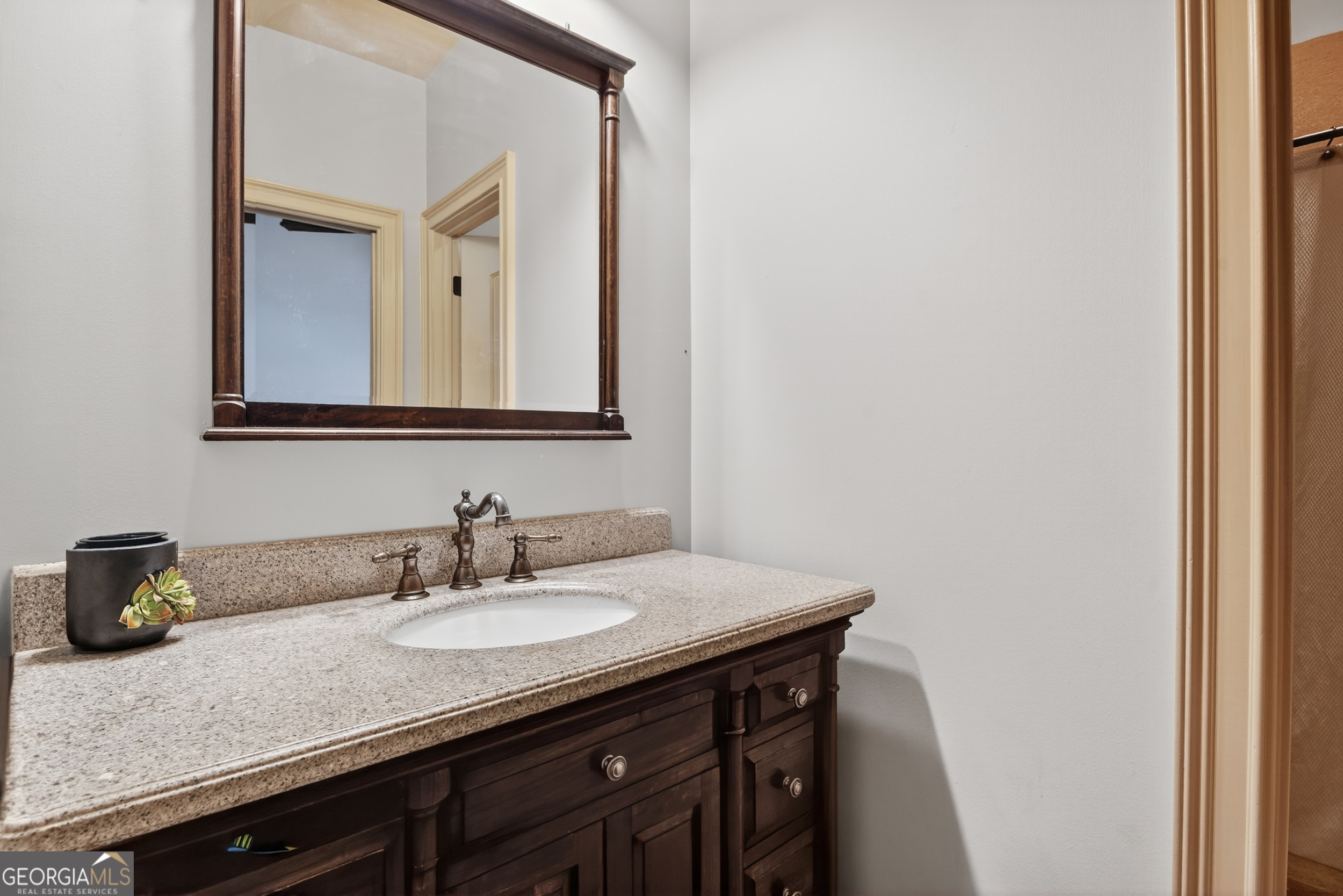 1583 Hickory Flat Road Gillsville, GA 30543 - Photo 15 of 79 a bathroom with a sink and a mirror