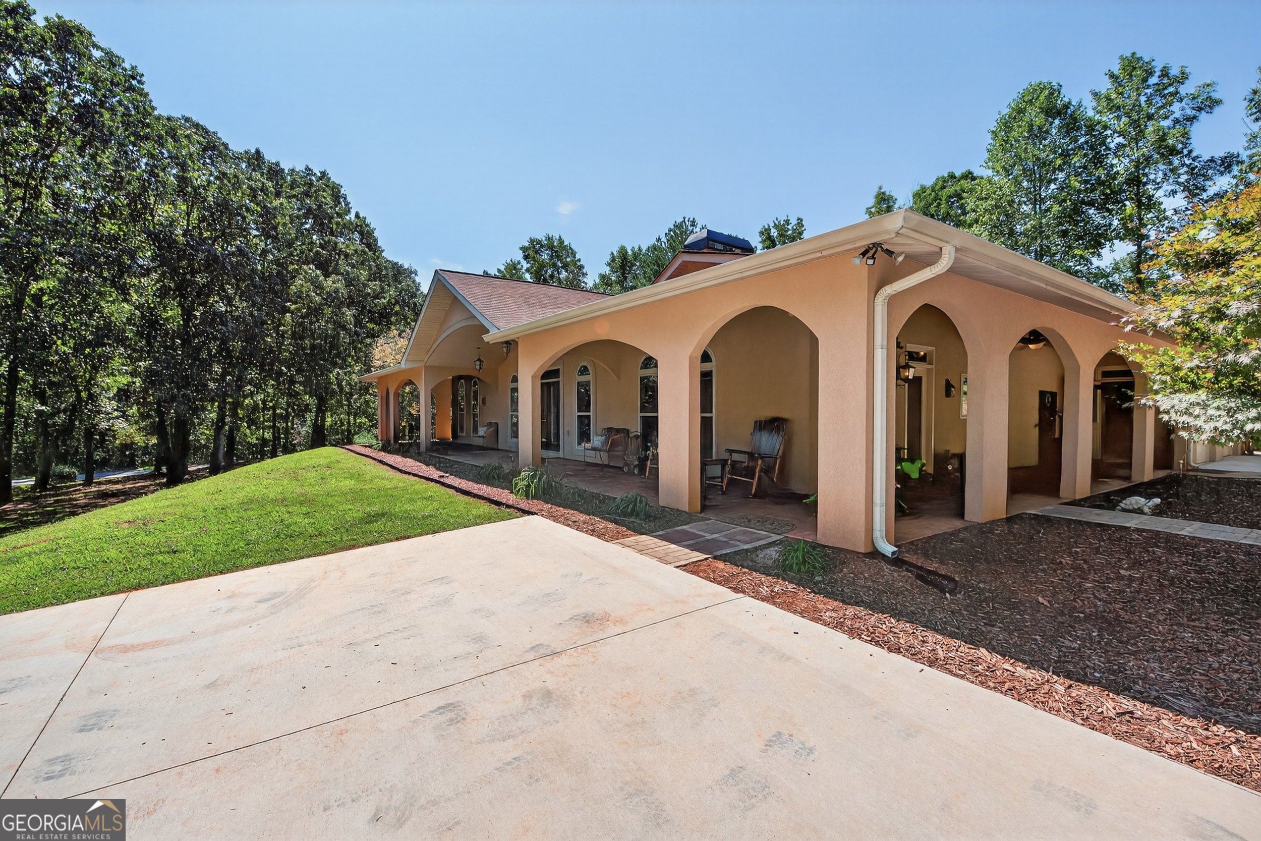 1583 Hickory Flat Road Gillsville, GA 30543 - Photo 60 of 79 a view of a white house with a yard and large tree and plants
