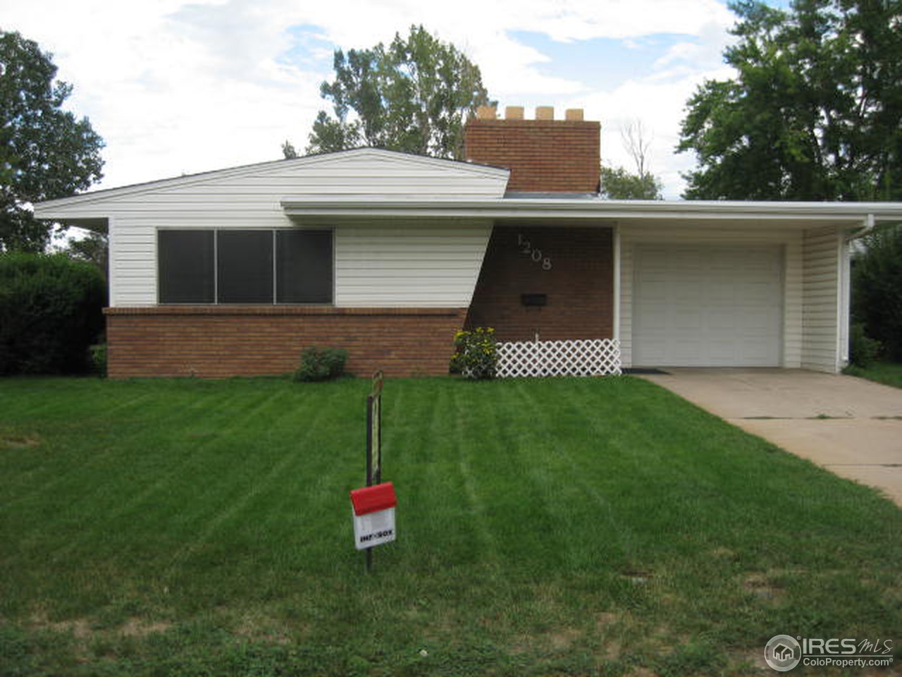 1208 Baker Street Fort Collins, CO 80524 - Photo 1 of 25 a front view of a house with a yard and garage