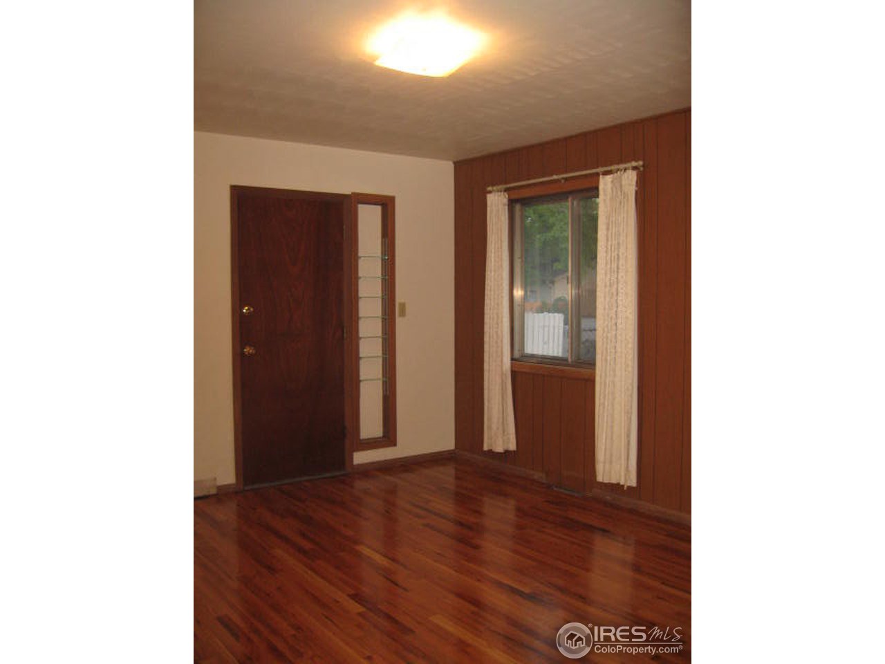 1208 Baker Street Fort Collins, CO 80524 - Photo 13 of 25 a view of an empty room with wooden floor