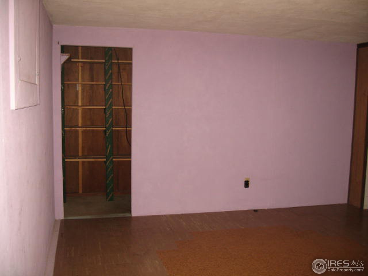 1208 Baker Street Fort Collins, CO 80524 - Photo 19 of 25 an empty room with a wooden door and a window