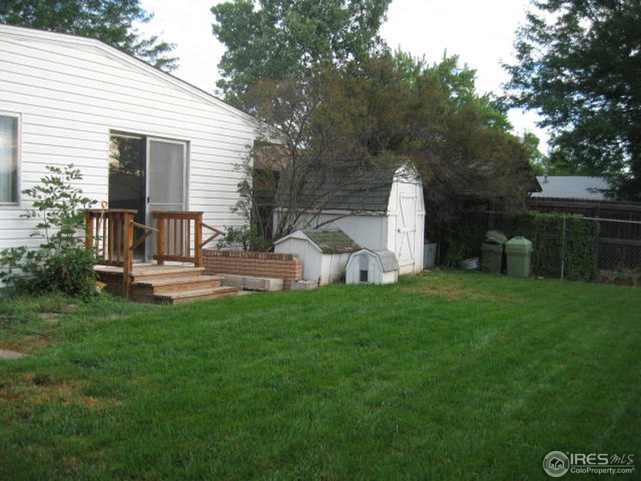 1208 Baker Street Fort Collins, CO 80524 - Photo 24 of 25 a front view of a house with garden and a tree
