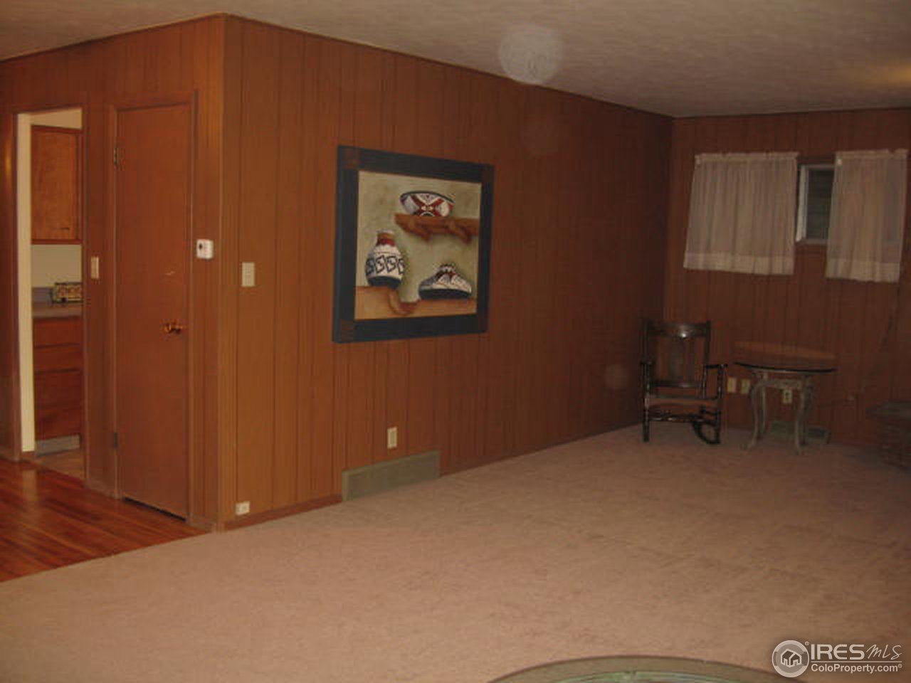 1208 Baker Street Fort Collins, CO 80524 - Photo 8 of 25 a view of an empty room with furniture and a lamp