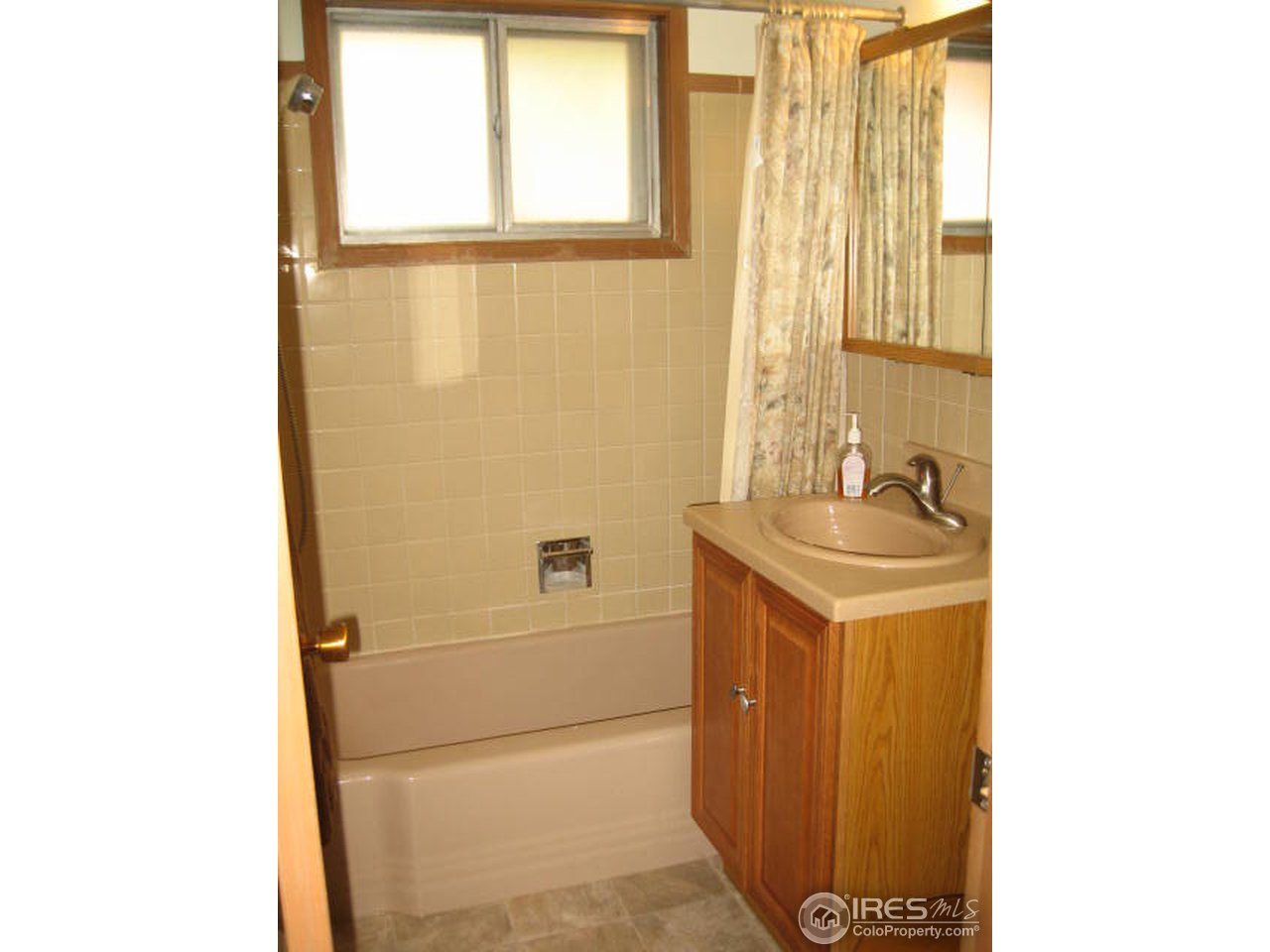 1208 Baker Street Fort Collins, CO 80524 - Photo 9 of 25 a bathroom with a sink and a mirror
