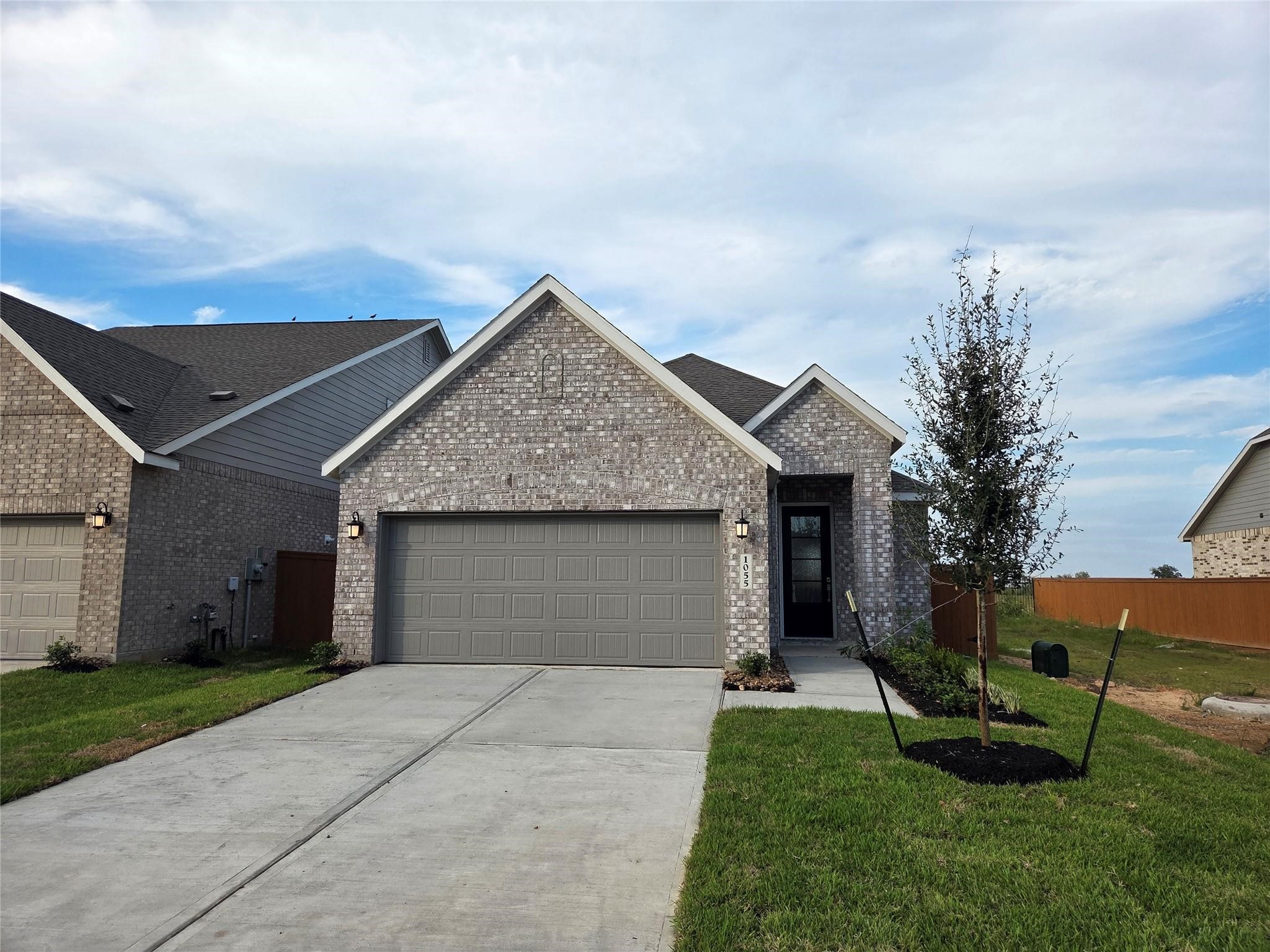 5718 Goosander Land Drive Baytown, TX 77521 - Photo 11 of 17 a front view of house with a garden