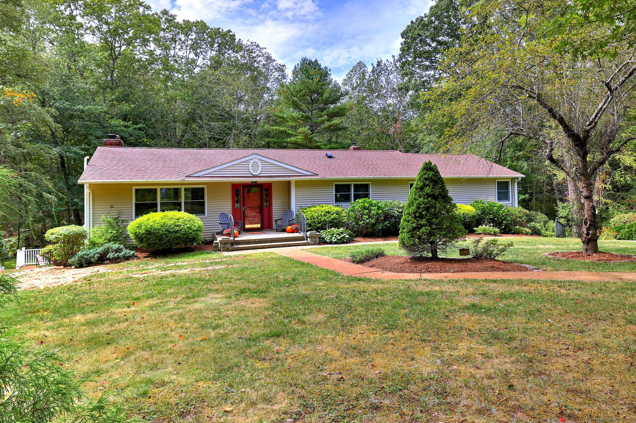 230 South Hoop Pole Road Guilford, CT 06437 - Photo 1 of 1 a front view of a house with a yard and trees
