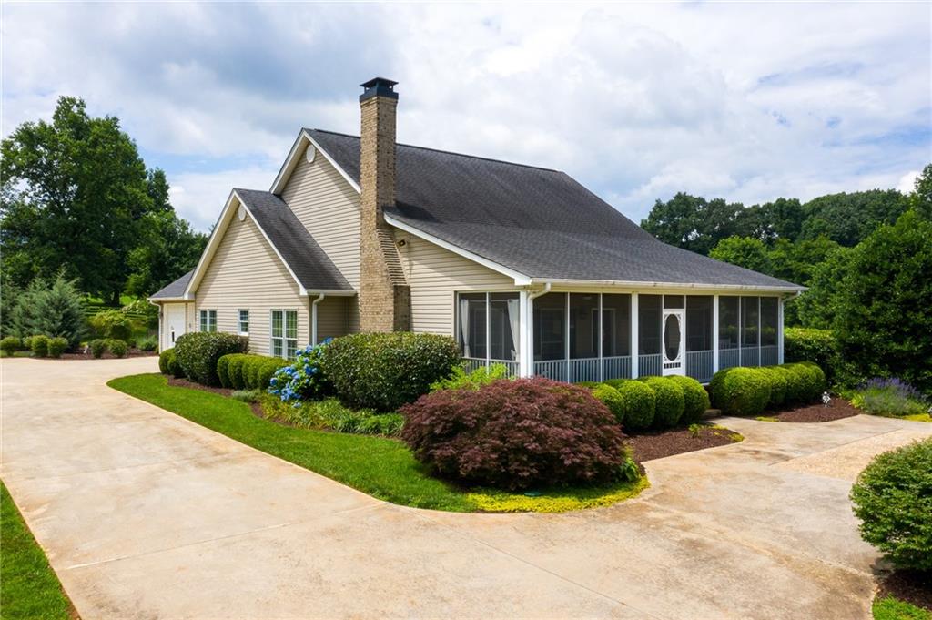 6455 Arrowhead Road Murrayville, GA 30564 - Photo 1 of 1 Front left side of home, screened porch that is also screened under decking to prevent bugs.