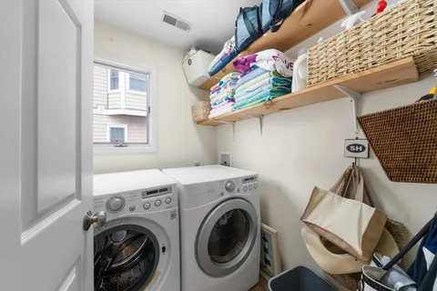 a view of a dining room with furniture large windows and wooden floor