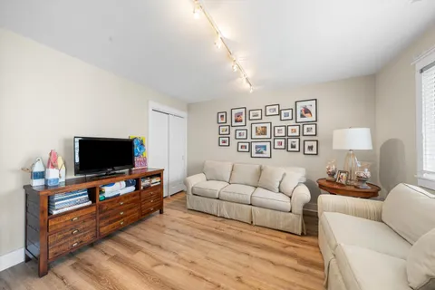 a living room with furniture and a wooden floor