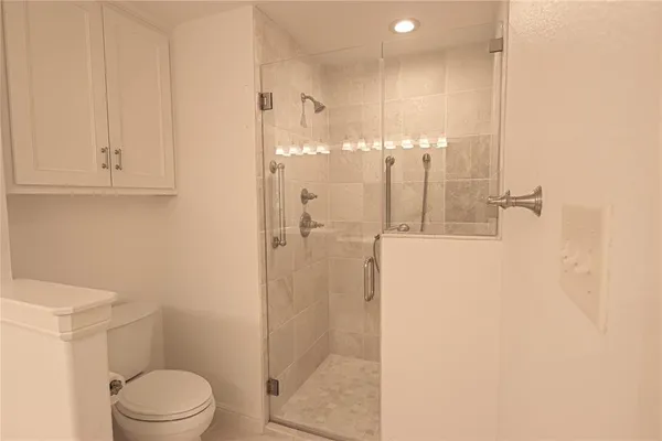 a bathroom with a shower a toilet and sink