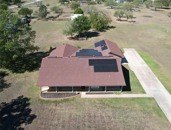 an aerial view of a house with a yard