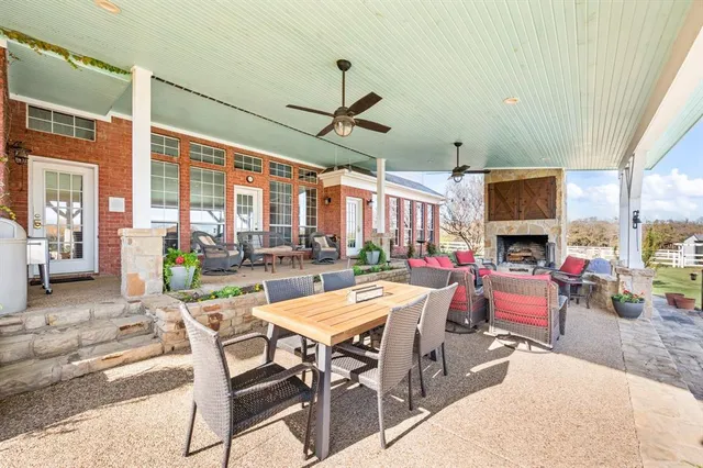 a building outdoor space with patio furniture and potted plants